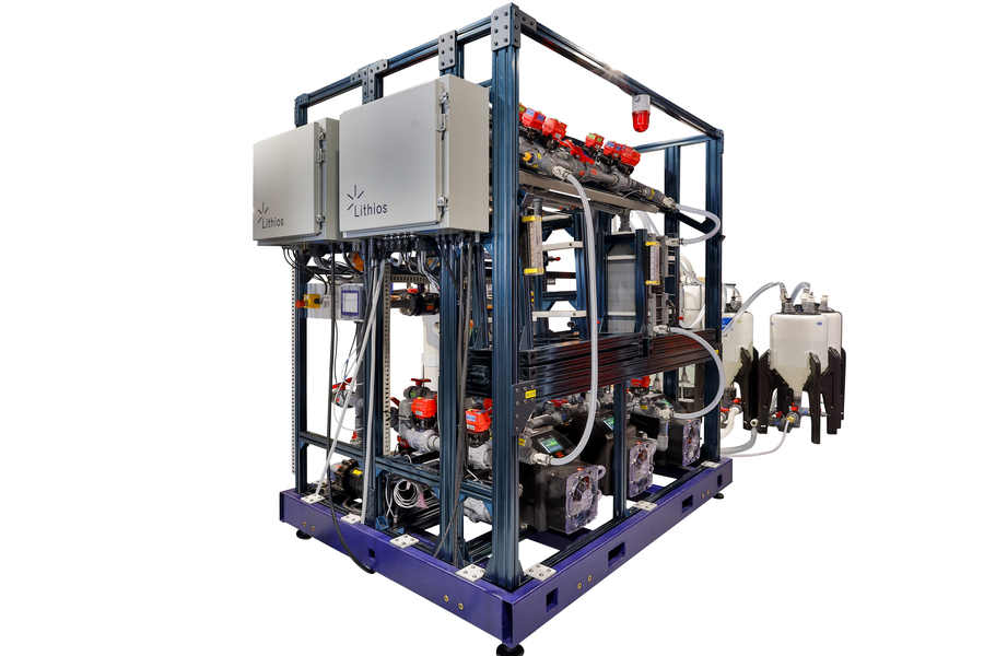 Industrial-scale modular system with metal frame, control panels labeled "Lithios," multiple pipes, valves, and fluid containers, designed for chemical or energy processing applications.