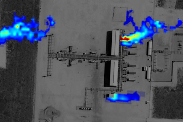 An overhead satellite image of a gas production site, with plumes of gas (colored to show concentration levels) emanating from 3 locations.